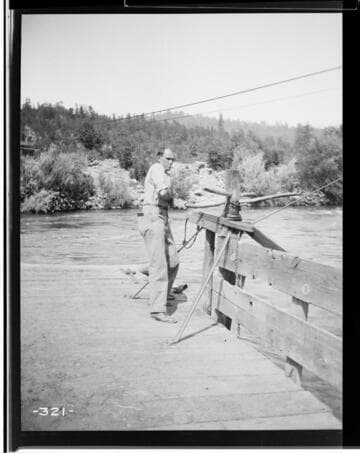 A man working on the ferry on the Pitt River for the Mount Shasta Power Company